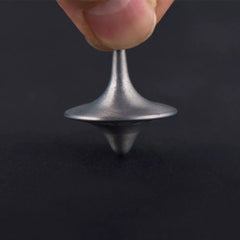 A silver-colored metal spinning top