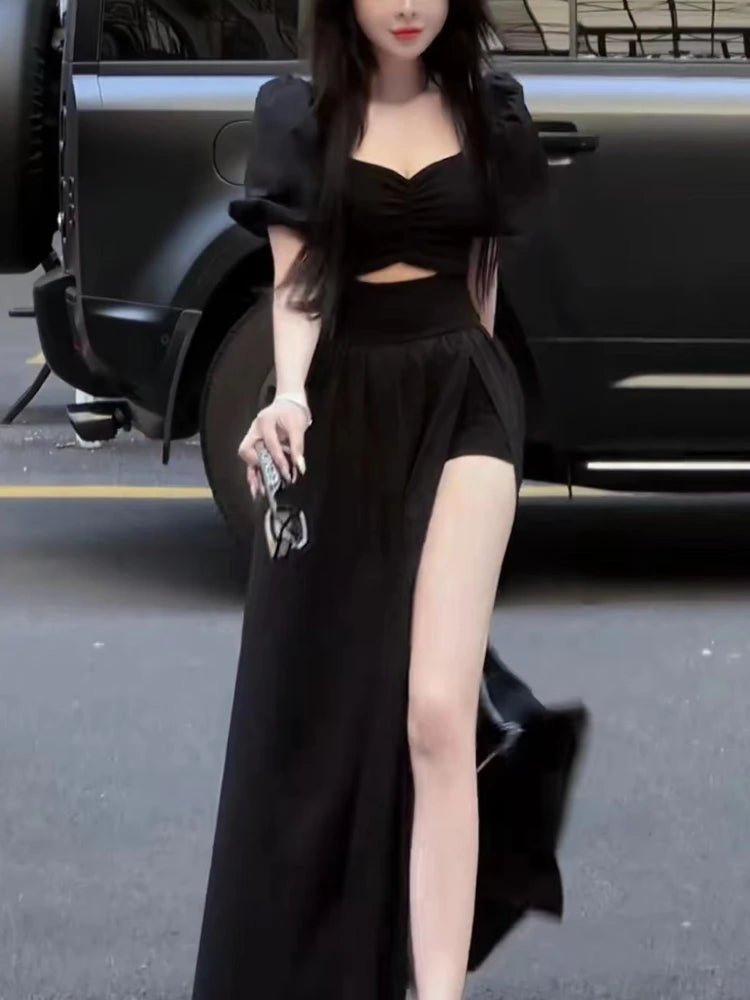 Woman in a black outfit standing next to a car
