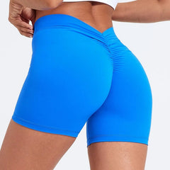 Blue athletic shorts worn by a person on a white background