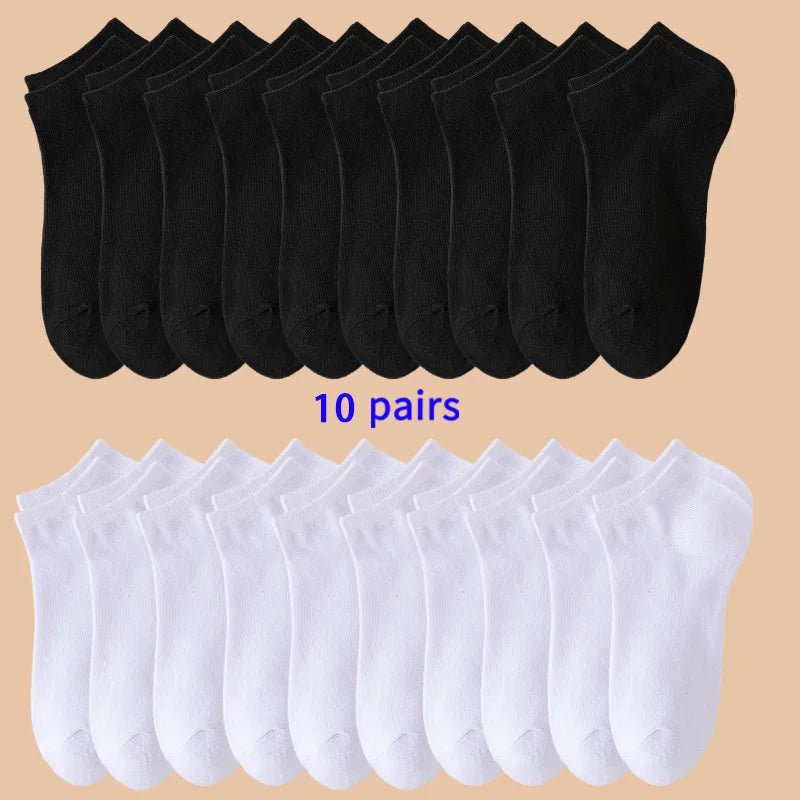10 pairs of black socks on top and 10 pairs of white socks on bottom against a beige background.