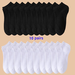 10 pairs of black socks on top and 10 pairs of white socks on bottom against a beige background.