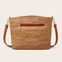 Cork handbag with brown leather accents on a beige background