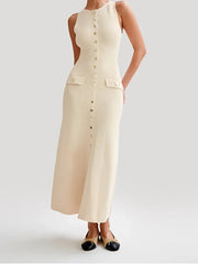 Woman wearing a beige sleeveless dress with buttons on a white background