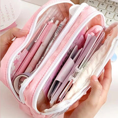 Pink pencil case with stationery items held by hands on a light background