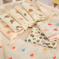 Folded fabric sheets with various patterns on a light background