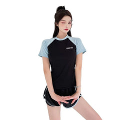 Woman wearing a black and light blue swimsuit with 'SWIM' text on a white background