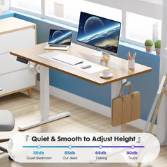 Modern office desk with adjustable height feature, computer setup, and office supplies.