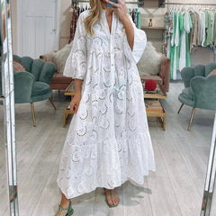 Woman wearing a white lace dress in a clothing store.
