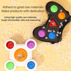 Fidget spinner with color-coded buttons on a textured surface