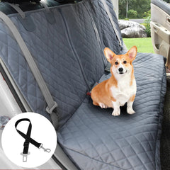 Dog sitting on a car seat cover with a leash attachment, inside a vehicle.