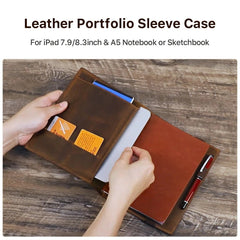 Brown leather portfolio sleeve case with compartments on a wooden surface