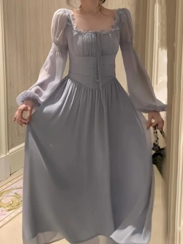 Woman wearing a light blue dress with long sleeves in an indoor setting