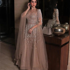 Woman in a sparkly dress standing next to a wooden cabinet with decorative items.