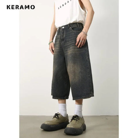 Person wearing wide-leg jeans and a white tank top with 'KERAMO' branding.