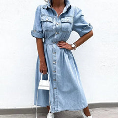Person wearing a light blue denim dress against a white background