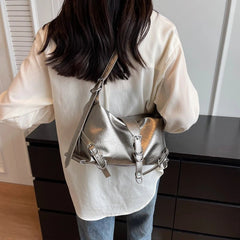 Person wearing a silver backpack indoors