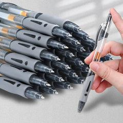 Stack of pens with a hand holding a pen on a light gray background