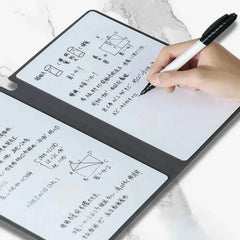 Hand holding a pen over a transparent writing pad with mathematical equations and diagrams.