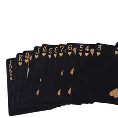 Black playing cards with gold lettering and heart symbols on a white background