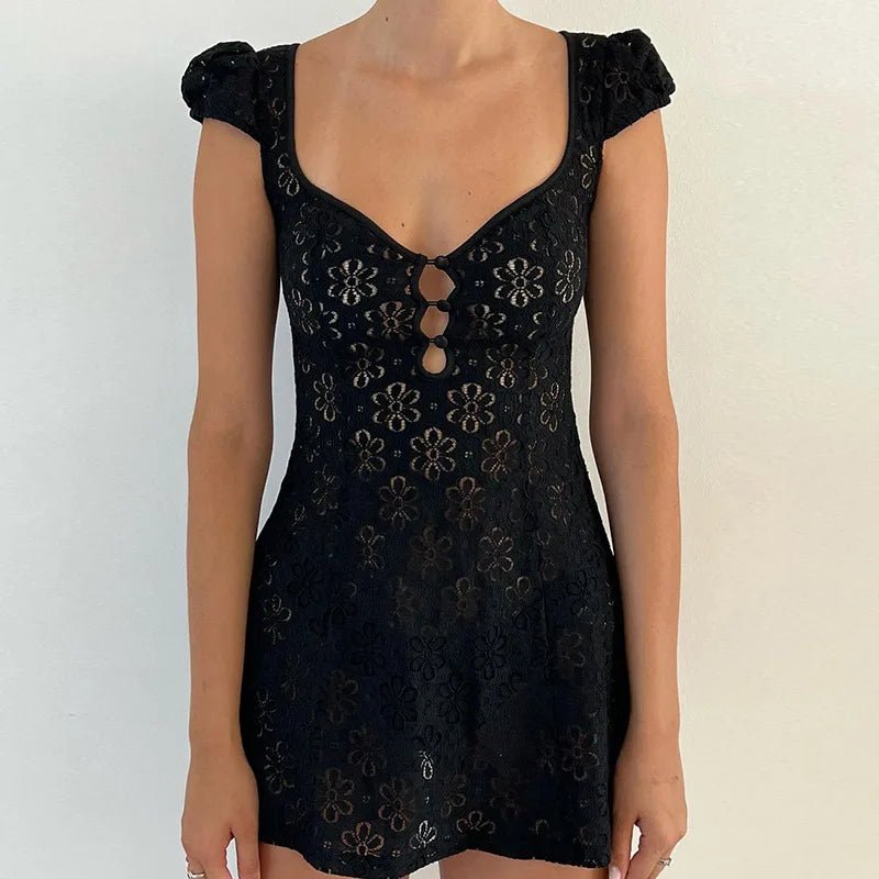 Black lace dress with floral patterns on a plain background