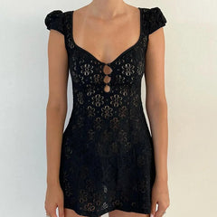 Black lace dress with floral patterns on a plain background