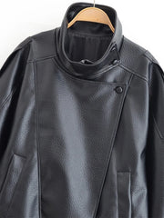 Black leather jacket on a hanger against a white background