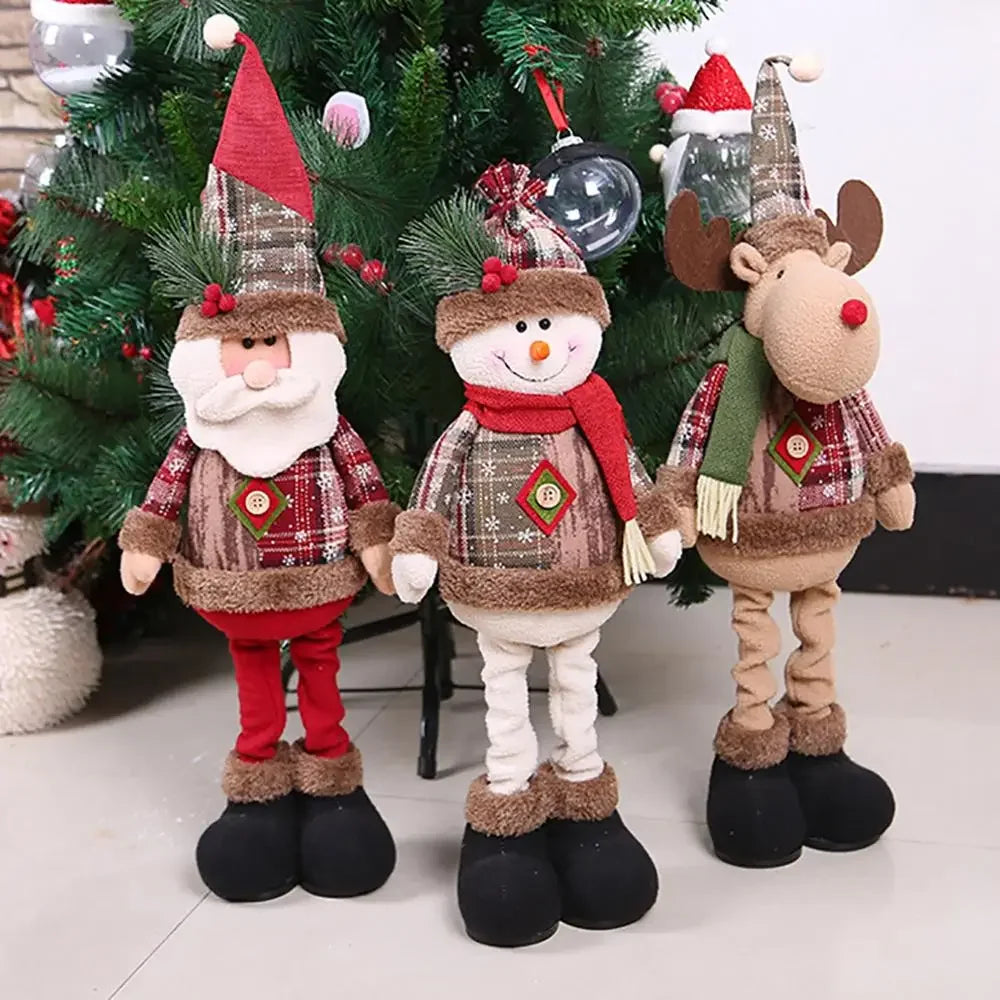 Three Christmas-themed decorations including a Santa Claus, snowman, and reindeer in front of a decorated tree.