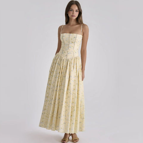 Woman wearing a yellow floral dress on a white background