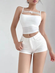 Person wearing a white sleeveless top and shorts on a plain background