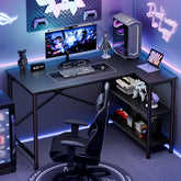Gaming setup with computer desk, chair, and gaming accessories in a room with blue lighting.