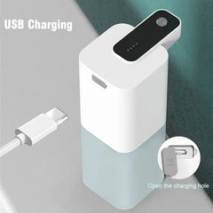 White electronic device with USB charging cable on a gray background