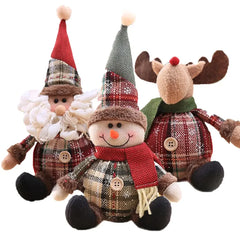Three Christmas-themed plush toys including a snowman, gnome, and reindeer on a white background.
