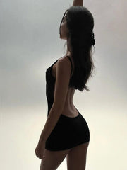 Silhouette of a person wearing a black sleeveless top and shorts against a light background