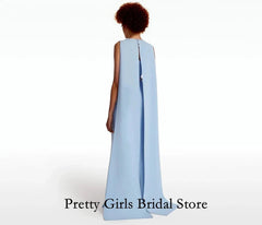 Woman wearing a light blue gown with a cape on a white background, branded 'Pretty Girls Bridal Store'.