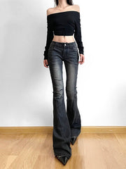 Person wearing a black off-shoulder top and dark jeans on a plain background