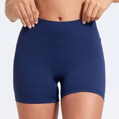 Navy blue athletic shorts worn by a person on a light gray background