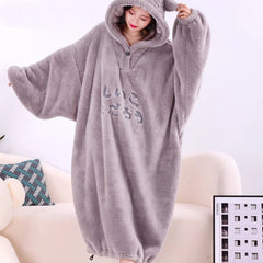 Person wearing a gray fleece onesie with a hood on a white background