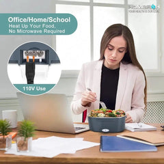 Woman eating salad at a desk with a portable food warmer, office/home/school setting.