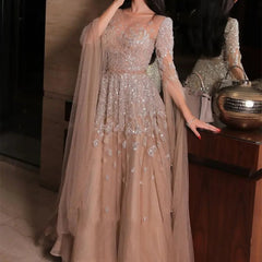 Woman in a sparkling evening gown with a handbag and decorative object in the background