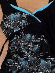 Black garment with blue floral patterns on a wooden surface