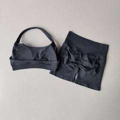 Black bikini set with a bow detail on a light gray background
