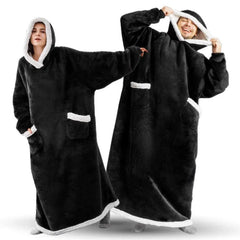 Two models wearing long black hooded robes with white fleece lining, posing with one model holding the hood of the other's robe.