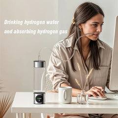 Woman using a hydrogen water device at a desk with text about drinking and absorbing hydrogen gas.