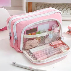 Pink pencil case with stationery items on a desk