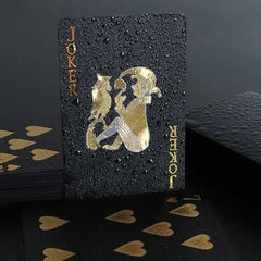 Black playing card with gold designs and 'JOKER' text on a dark background