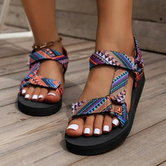 Colorful patterned sandals on a wooden floor