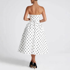 White strapless dress with black polka dots on a white background