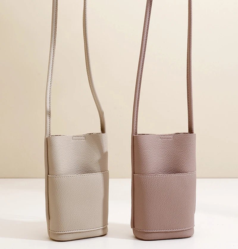 Two small bags with straps on a beige background