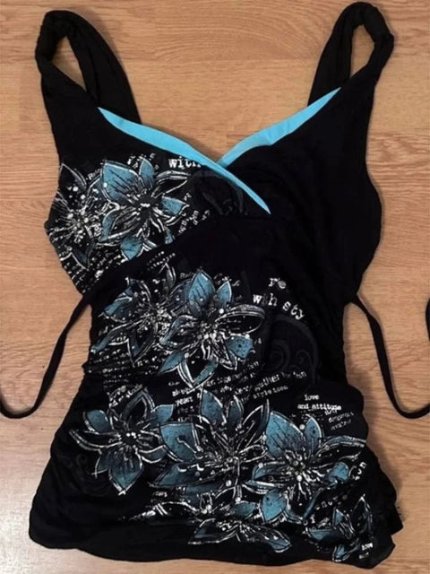 Black swimsuit with floral patterns on a wooden surface