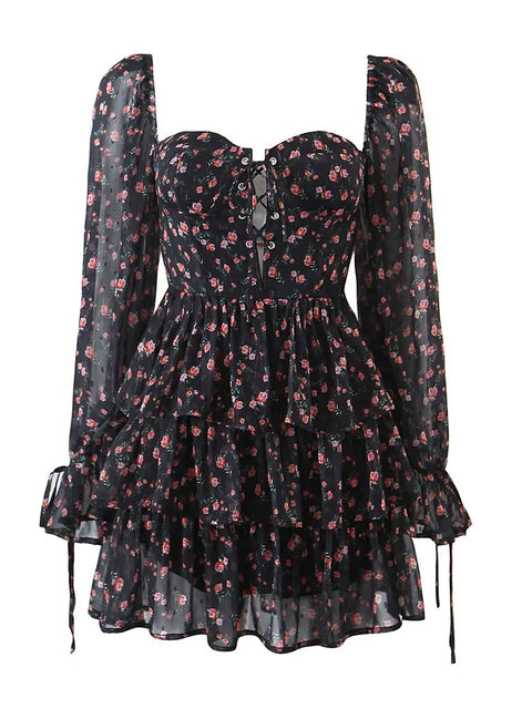 Black floral dress with sheer long sleeves on a white background